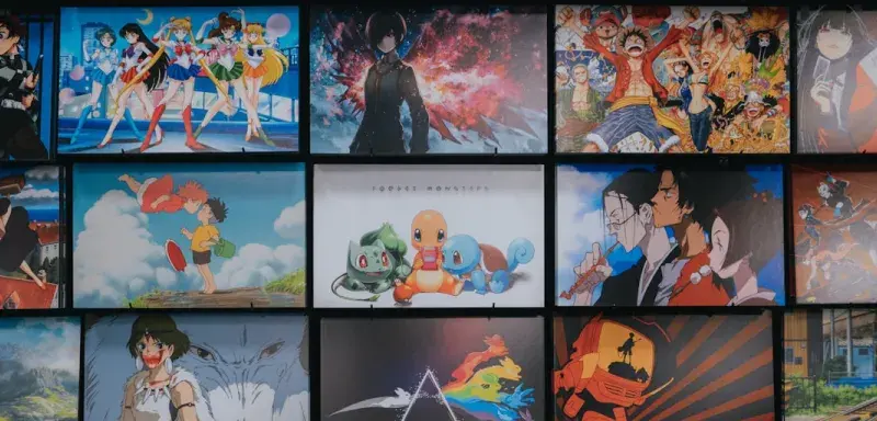 anime character collage photo on black wooden shelf