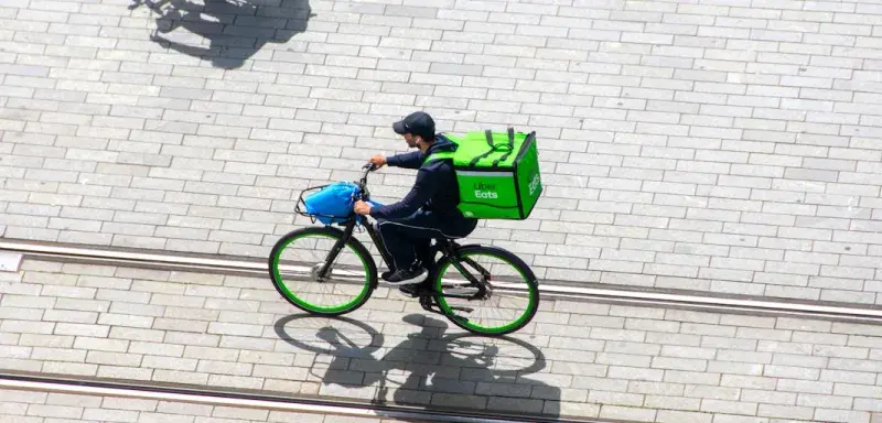 a man riding a bike down a street