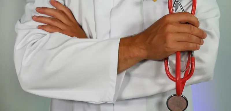 doctor holding red stethoscope