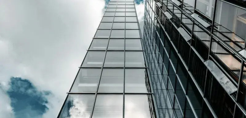 low angle photography of high rise building under cloudy sky