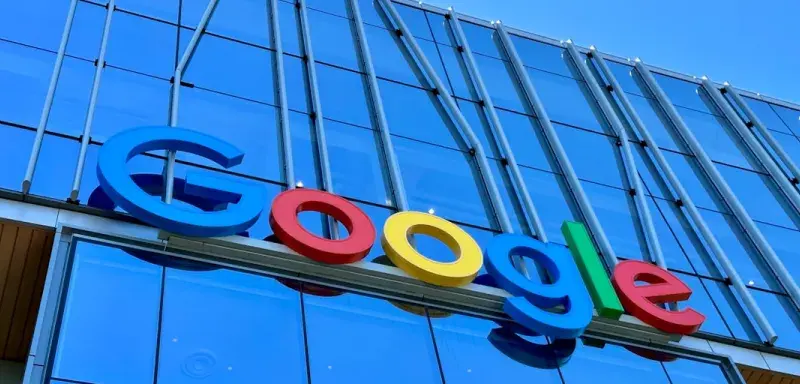 the google logo is displayed on the side of a building