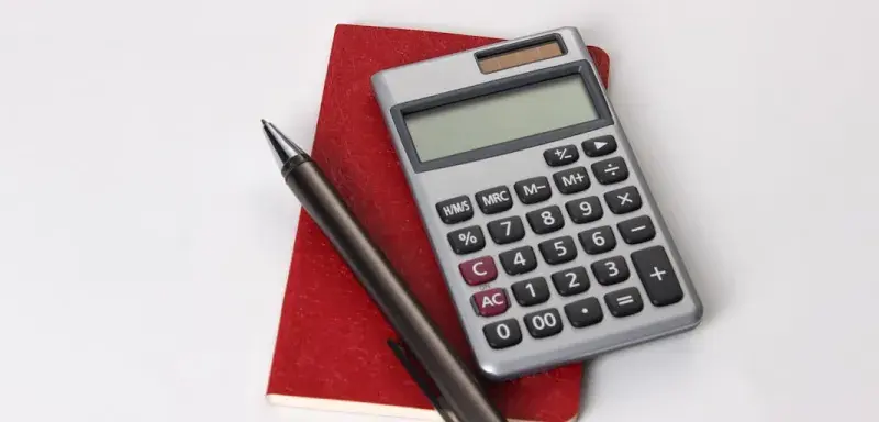 black and silver calculator beside black pen