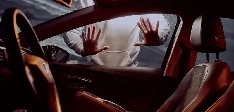 man in white long sleeve shirt driving car