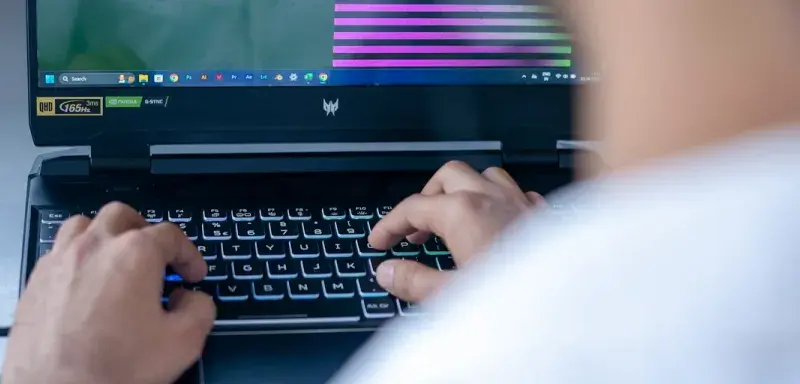 a man sitting in front of a laptop computer