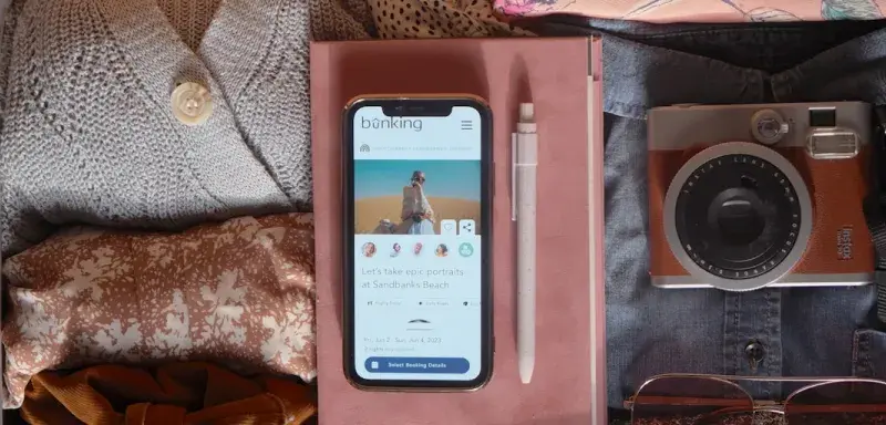 an open suitcase with a cell phone and other items