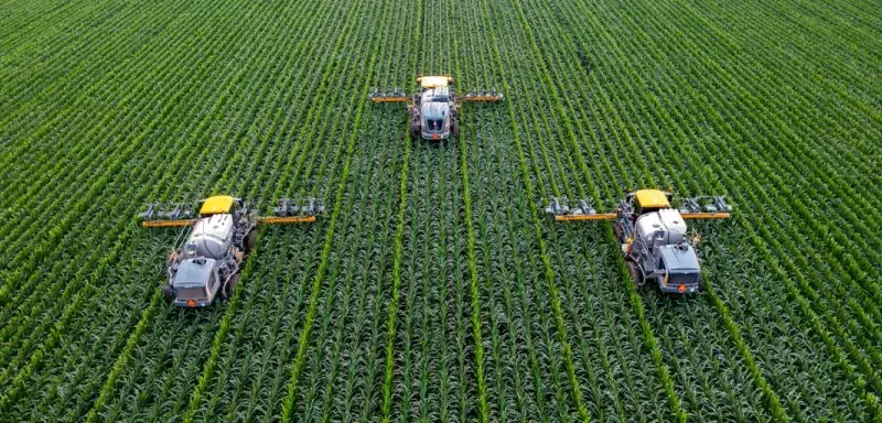 yellow and black heavy equipment on green field during daytime
