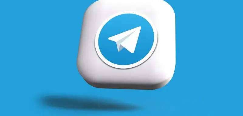 a blue and white square button with a paper airplane on it