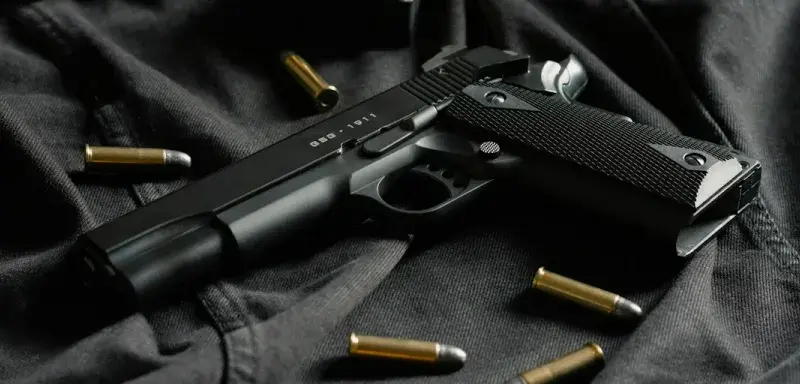 black semi automatic pistol on black textile