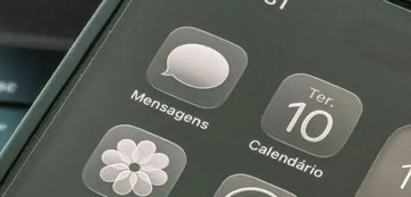 Close-up shot of a smartphone displaying apps and calendar on the screen.