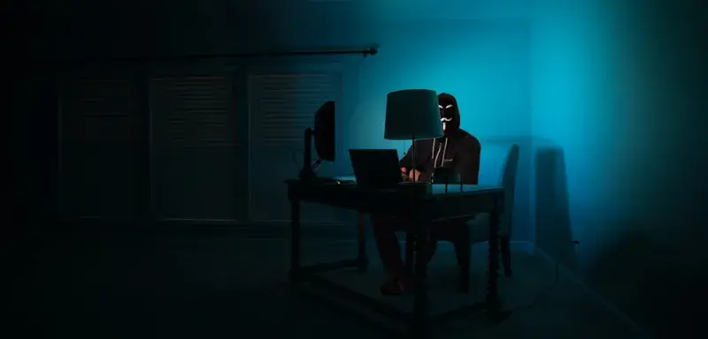 man siting facing laptop
