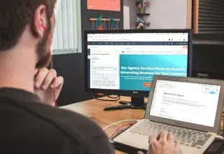 man sitting on chair using silver laptop
