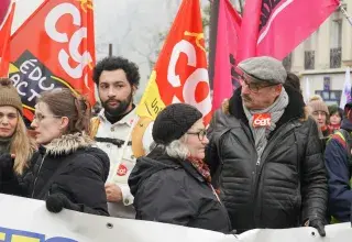 A large group of people holding a banner