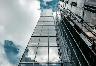 low angle photography of high rise building under cloudy sky
