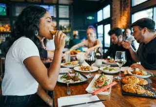 woman in white shirt eating