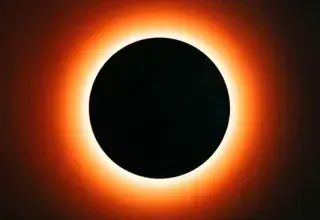 Dramatic view of a total solar eclipse showcasing a fiery ring illuminating the dark circle.