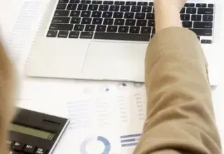 Business professional analyzing financial data on a laptop for strategic decision making.