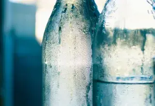 clear glass bottle with water
