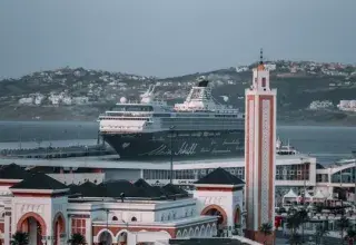Ambient cityscape of Tangier featuring a cruise ship and unique Moroccan architecture.