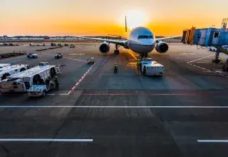 gray airplane on parking
