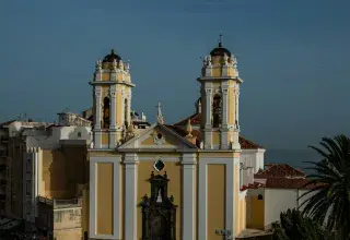 A large yellow and white building with two towers