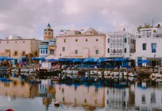 Picturesque harbor in Bizerte, Tunisia with traditional white buildings and boats.
